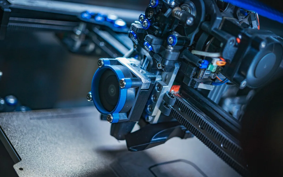 Detailed view of a high-tech 3D printer mechanism showcasing precision engineering.