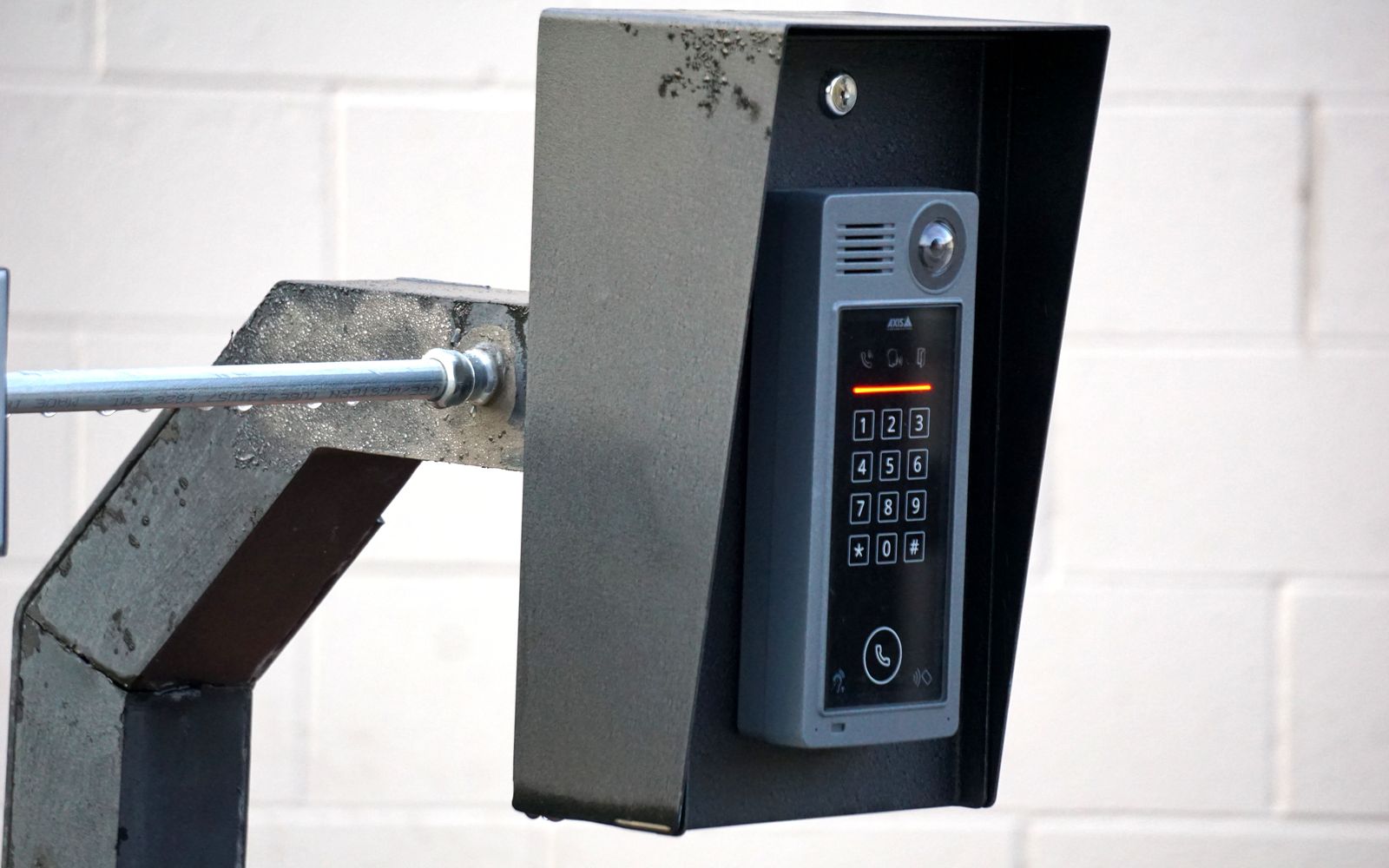 An access control reader mounted at a vehicle gate