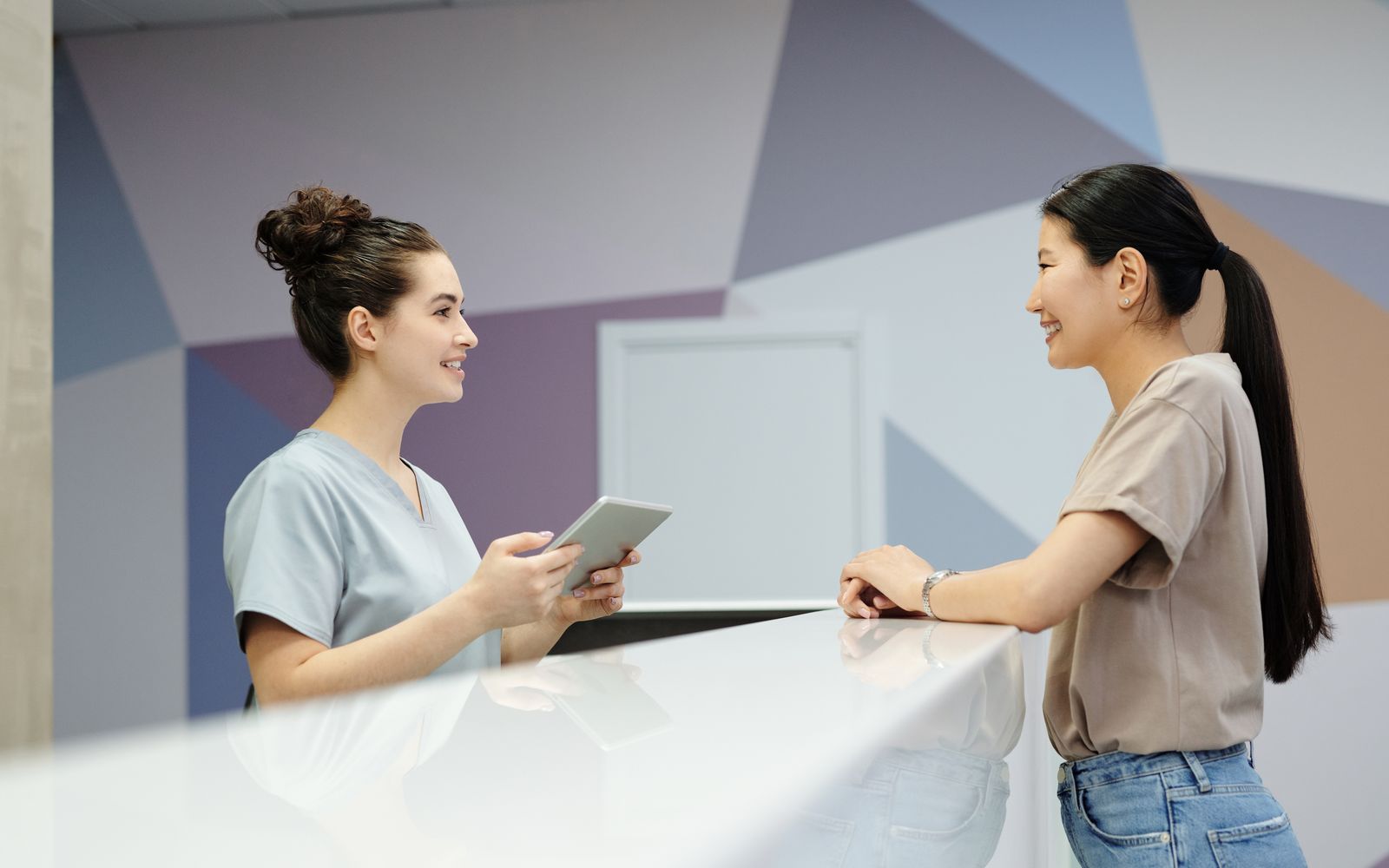 A visitor being checked in at an office reception desk